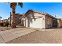 Charming single-story home featuring a two-car garage and desert landscaping at 3232 E Hononegh Dr, Phoenix, AZ 85050