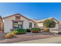 Lovely single-story home featuring a landscaped front yard with desert rock and shrubs at 3365 W Abraham Ln, Phoenix, AZ 85027