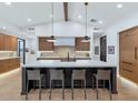 Modern kitchen with a large island, stainless steel appliances, and stylish pendant lighting at 3511 E Orange Dr, Phoenix, AZ 85018