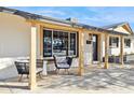 Inviting covered porch featuring contemporary furniture and natural wood accents with a view of the front yard at 3803 S Elm St, Tempe, AZ 85282