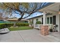 Picturesque view of the side yard, with a beautiful tree, lush greenery and comfortable seating at 3922 E Elm St, Phoenix, AZ 85018