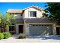 Inviting two-story home featuring a neutral stucco facade, well-kept landscaping, and a spacious two car garage at 4757 E Amber Sun Dr, Cave Creek, AZ 85331