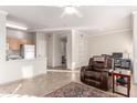 Open living space featuring tile floors, a ceiling fan, and an adjacent kitchen and office area at 5401 E Van Buren St # 2050, Phoenix, AZ 85008