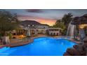 A private in-ground pool with a waterfall feature and surrounding patio is perfect for entertaining at 616 E Carver Rd, Tempe, AZ 85284