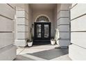 Grand front entrance features textured pillars and black double doors at 7318 W Paso Trl, Peoria, AZ 85383