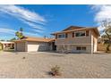 Beautiful home with a front-facing garage, desert rock landscaping and an interesting tree in the front yard at 7539 N 50Th Ave, Glendale, AZ 85301