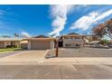 Charming home showcasing a well-kept front yard, a spacious garage, and a quaint mailbox post at 7539 N 50Th Ave, Glendale, AZ 85301