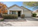 Inviting single-story home featuring a covered porch, desert landscaping, and an attached two-car garage at 7924 S 24Th Pl, Phoenix, AZ 85042