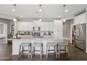 Kitchen with a large center island, granite counters, and barstool seating at 7924 S 24Th Pl, Phoenix, AZ 85042