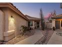 Charming desert landscaped home exterior with a well-lit entrance and neutral stucco at 80 S Maple Ct, Chandler, AZ 85226