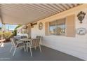 Covered patio featuring a comfortable seating area and awning at 8233 E Calypso Ave, Mesa, AZ 85208