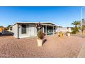 Quaint one-story home with low maintenance landscaping, carport and cozy screened in porch area at 8258 E Calypso Ave, Mesa, AZ 85208