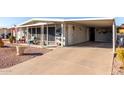 Cozy single-story home boasts a covered carport and a screened front patio, perfect for outdoor relaxation at 8258 E Calypso Ave, Mesa, AZ 85208