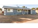 Charming single-story home with a gray exterior, covered entry, and low-maintenance landscaping at 836 S Pasadena St, Mesa, AZ 85210