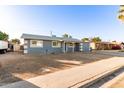 Charming single-story home with a gray exterior, covered entry, and low-maintenance landscaping at 836 S Pasadena St, Mesa, AZ 85210