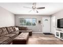 Cozy living room with a large window, modern ceiling fan, and stylish furnishings at 9134 E Gary Ln, Mesa, AZ 85207