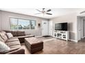 Cozy living room with a large window, modern ceiling fan, and stylish furnishings at 9134 E Gary Ln, Mesa, AZ 85207