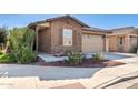 Cozy home with brick facade, a two-car garage and manicured landscaping at 9341 W Willow Bend Ln, Phoenix, AZ 85037