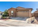 Cozy home with brick facade, a two-car garage and manicured landscaping at 9341 W Willow Bend Ln, Phoenix, AZ 85037