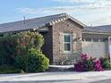 Attractive single-story home featuring brick veneer, desert landscaping, and a neutral color palette at 9341 W Willow Bend Ln, Phoenix, AZ 85037