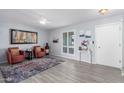 Cozy living room with wood-look tile flooring, ceiling fan, and neutral color palette at 10105 W Bolivar Dr, Sun City, AZ 85351