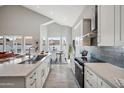 Bright kitchen featuring a large island, white cabinetry, stainless steel appliances and lots of light at 11537 W Laurelwood Ln, Avondale, AZ 85392