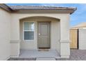 Close-up of the home's front entrance, featuring a covered porch and desert landscaping at 12089 E Sunflower Ln, Florence, AZ 85132