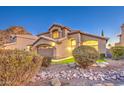Charming two-story home with a well-manicured front yard landscape, gravel and desert plants at dusk at 1349 E Rock Wren Rd, Phoenix, AZ 85048
