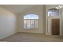Bright living room featuring high ceilings, wood-look tile floors and large windows at 1349 E Rock Wren Rd, Phoenix, AZ 85048