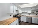 Bright kitchen featuring white cabinets, butcher block countertops, and stainless steel appliances at 2040 S Longmore -- # 5, Mesa, AZ 85202