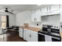 Well-lit kitchen with white cabinetry, butcher block countertops, and a dining area nearby at 2040 S Longmore -- # 5, Mesa, AZ 85202
