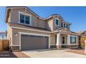 Two-story home shows off a gray garage door, neutral stucco, and manicured front yard at 20941 E Via Del Sol St, Queen Creek, AZ 85142