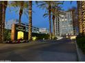 Elegant entrance to 2211 Camelback features lush landscaping and a modern building at twilight at 2211 E Camelback Rd # 306, Phoenix, AZ 85016
