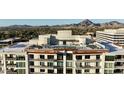 Stunning rooftop pool and lounge area with breathtaking mountain views and modern design elements at 2211 E Camelback Rd # 306, Phoenix, AZ 85016