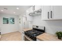 Modern kitchen with stainless steel appliances, wooden countertops, and white cabinets at 2904 W Coolidge St, Phoenix, AZ 85017