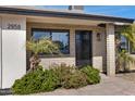 Charming brick home featuring a black front door, manicured landscaping, and a well-lit entry at 2958 E Contessa St, Mesa, AZ 85213