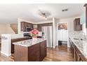 Charming kitchen with stainless steel appliances, granite countertops, and wooden cabinetry at 317 W Settlers Trl, Casa Grande, AZ 85122