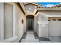 Inviting entryway featuring decorative front door, covered porch, and well-maintained landscaping enhancing curb appeal at 42072 W Dorsey Dr, Maricopa, AZ 85138