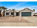 Charming single-story home with a well-kept desert landscaped front yard, and attached garage at 6303 E Preston St, Mesa, AZ 85215