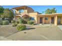 View of home with well kept landscaping, driveway and beautiful exterior paint at 7530 E Mariposa Dr, Scottsdale, AZ 85251