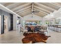 Open-concept living space with statement ceiling beams, stylish furnishings, and an inviting atmosphere at 7816 S Lakeshore Dr, Tempe, AZ 85284