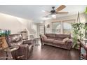 Bright living room with hardwood floors, ceiling fan, and comfortable seating area at 1042 S Cheshire Ln, Gilbert, AZ 85296