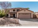 Home with desert landscaping, two-car garage, and a cozy covered front porch area at 1114 S Grenoble --, Mesa, AZ 85208