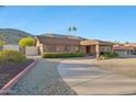 Lovely brick home with circular driveway, mature landscaping, and a covered front porch at 1201 W Dahlia Dr, Phoenix, AZ 85029