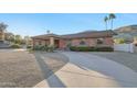 Attractive brick home featuring a circular driveway and well-maintained front yard landscaping at 1201 W Dahlia Dr, Phoenix, AZ 85029