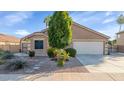 Charming single-story home with a well-manicured front yard and two-car garage at 1363 N Mckenna Ln, Gilbert, AZ 85233