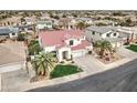 Charming two-story home boasting a red tile roof, lush green lawn, and an attached three-car garage at 14674 W Windsor Ave, Goodyear, AZ 85395