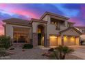 Beautiful home with a stone facade, three-car garage, and manicured front yard at 15652 N 175Th Ct, Surprise, AZ 85388