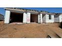 New construction home, still in progress, showcasing the framing and initial stages of exterior construction at 15770 W Cheryl Dr, Waddell, AZ 85355