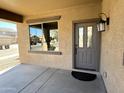 Inviting front porch with decorative front door, stylish light fixture, and large window at 1637 W Green Tree Dr, San Tan Valley, AZ 85144